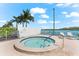 Relaxing hot tub area with palm trees and waterfront views at 9397 Midnight Pass Rd # 906, Sarasota, FL 34242