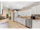 Well-equipped kitchen with granite countertops and white cabinets at 9397 Midnight Pass Rd # 906, Sarasota, FL 34242