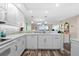 Updated kitchen with white cabinets, quartz countertops, and stainless steel appliances at 9397 Midnight Pass Rd # 906, Sarasota, FL 34242
