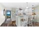 Updated kitchen with white cabinets, granite counters, and breakfast bar at 9397 Midnight Pass Rd # 906, Sarasota, FL 34242