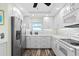 White kitchen with stainless steel appliances and view to living area at 9397 Midnight Pass Rd # 906, Sarasota, FL 34242