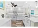 Updated white kitchen with tile backsplash and wood-look floors at 9397 Midnight Pass Rd # 906, Sarasota, FL 34242