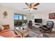 Living area featuring a sofa, armchairs, and balcony access at 9397 Midnight Pass Rd # 906, Sarasota, FL 34242