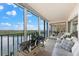 Sunroom with comfy seating and water views at 9397 Midnight Pass Rd # 906, Sarasota, FL 34242