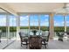 Sunroom with glass-top table and chairs at 9397 Midnight Pass Rd # 906, Sarasota, FL 34242