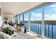 Sunroom with water views and comfortable seating at 9397 Midnight Pass Rd # 906, Sarasota, FL 34242