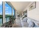 Spacious sunroom with water views and seating at 9397 Midnight Pass Rd # 906, Sarasota, FL 34242
