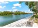 Scenic waterfront pathway with a relaxing bench at 9397 Midnight Pass Rd # 906, Sarasota, FL 34242