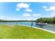Scenic waterfront view with boat and lush green landscaping at 9397 Midnight Pass Rd # 906, Sarasota, FL 34242