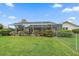 Spacious backyard featuring a screened pool and lush greenery at 964 E Gondola Dr, Venice, FL 34293