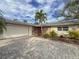 One-story home with attached garage and landscaped yard at 1887 Rita St, Sarasota, FL 34231