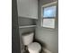 Simple toilet and storage in a small bathroom at 2820 Wood St, Sarasota, FL 34237