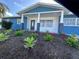 Inviting home exterior with blue siding, white trim, and landscaped yard at 2820 Wood St, Sarasota, FL 34237