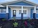 Newly renovated home exterior boasts a charming front porch and updated landscaping at 2820 Wood St, Sarasota, FL 34237