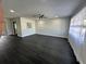 Spacious living room with dark gray vinyl flooring and ceiling fan at 2820 Wood St, Sarasota, FL 34237