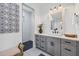 Bathroom with walk-in shower, gray cabinets, and a modern vanity at 0 Symco Ave, North Port, FL 34286