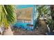 Side view of teal mobile home with tropical landscaping at 10315 Cortez W Rd # 47-2, Bradenton, FL 34210