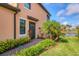 Exterior view of home with walkway and landscaping at 10796 Tarflower Dr # 102, Venice, FL 34293