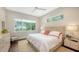 Bright bedroom with hardwood floors, comfortable bed, and ample natural light at 1103 Citrus Ave, Sarasota, FL 34236