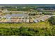 Aerial view of houses and a lake in a residential community at 11877 Hunters Creek Rd, Venice, FL 34293