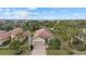 Aerial view of single-story home with tile roof, driveway, and lush landscaping at 12606 Fontana Loop, Bradenton, FL 34211