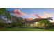Stunning backyard view at sunset, showcasing home's exterior and landscaping at 12606 Fontana Loop, Bradenton, FL 34211