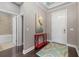 Elegant entryway with hardwood floors, a view of the bathroom, and a red console table at 12606 Fontana Loop, Bradenton, FL 34211