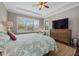 Spacious main bedroom with wood floors and large TV at 12606 Fontana Loop, Bradenton, FL 34211