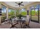 Relaxing screened patio with seating area, table, and lush landscaping views at 12606 Fontana Loop, Bradenton, FL 34211