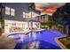Luxury home with a stunning pool, spa, and waterfall feature at dusk at 129 Mckinley Dr, Sarasota, FL 34236