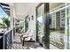 Relaxing balcony with comfortable seating and glass doors at 129 Mckinley Dr, Sarasota, FL 34236