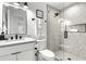 Clean bathroom with white vanity, black fixtures, and a glass shower at 129 Mckinley Dr, Sarasota, FL 34236