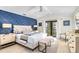 King bedroom with blue and white decor and private balcony access at 129 Mckinley Dr, Sarasota, FL 34236