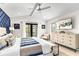 King bedroom with blue and white decor and private balcony access at 129 Mckinley Dr, Sarasota, FL 34236