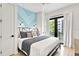 Bright bedroom with a king-size bed and access to a private balcony at 129 Mckinley Dr, Sarasota, FL 34236