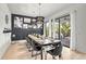 Elegant dining room with a large table, black chairs, and a statement chandelier at 129 Mckinley Dr, Sarasota, FL 34236