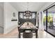 Elegant dining room with a large table, black chairs, and a statement chandelier at 129 Mckinley Dr, Sarasota, FL 34236