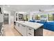 Modern kitchen with white cabinets, a large island, and stainless steel appliances at 129 Mckinley Dr, Sarasota, FL 34236