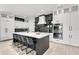 Modern kitchen with white cabinets, black accents and a large island at 129 Mckinley Dr, Sarasota, FL 34236