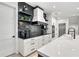 Modern kitchen with white cabinets, black accents, and geometric backsplash at 129 Mckinley Dr, Sarasota, FL 34236