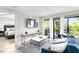 Living room with sofa, TV, and access to a deck at 129 Mckinley Dr, Sarasota, FL 34236