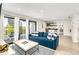 Living area with blue sofa and access to the deck at 129 Mckinley Dr, Sarasota, FL 34236
