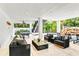 Outdoor patio with seating area, ping pong table, and lush greenery at 129 Mckinley Dr, Sarasota, FL 34236