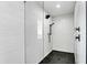 Sleek walk-in shower with wave patterned tile and glass enclosure at 129 Mckinley Dr, Sarasota, FL 34236