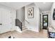 Modern staircase with black railing and light wood floors at 129 Mckinley Dr, Sarasota, FL 34236