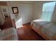 Spacious bedroom with two twin beds, large closet, and wood floors at 1564 Blind Brook Dr, Sarasota, FL 34234