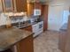 Kitchen with wood cabinets, white appliances, and a double sink at 1564 Blind Brook Dr, Sarasota, FL 34234