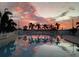 Community pool reflecting sunset colors at 1564 Blind Brook Dr, Sarasota, FL 34234