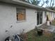 House exterior with damaged window and sliding door at 1814 6Th E Ave, Bradenton, FL 34208