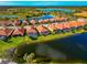 Aerial view of upscale homes, featuring multiple pools and lush landscaping at 24160 Gallberry Dr, Venice, FL 34293